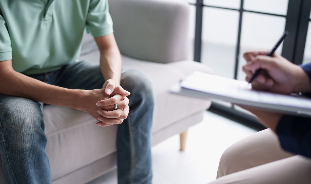 Man sitting on couch talking to provider